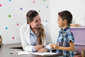 happy educational psychologist with young boy