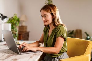 young woman working from home on her laptop