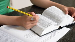 student with books open