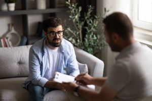 therapist talking with man over issues